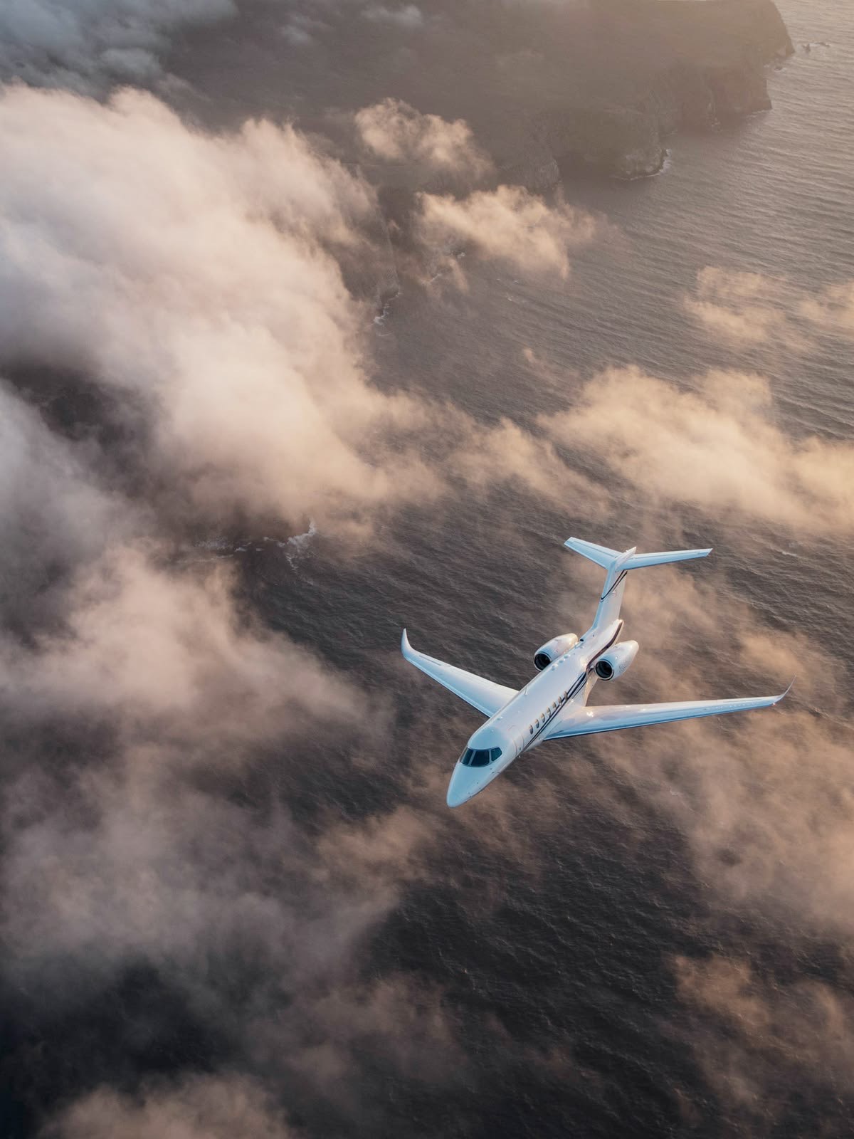 Private jet above the clouds